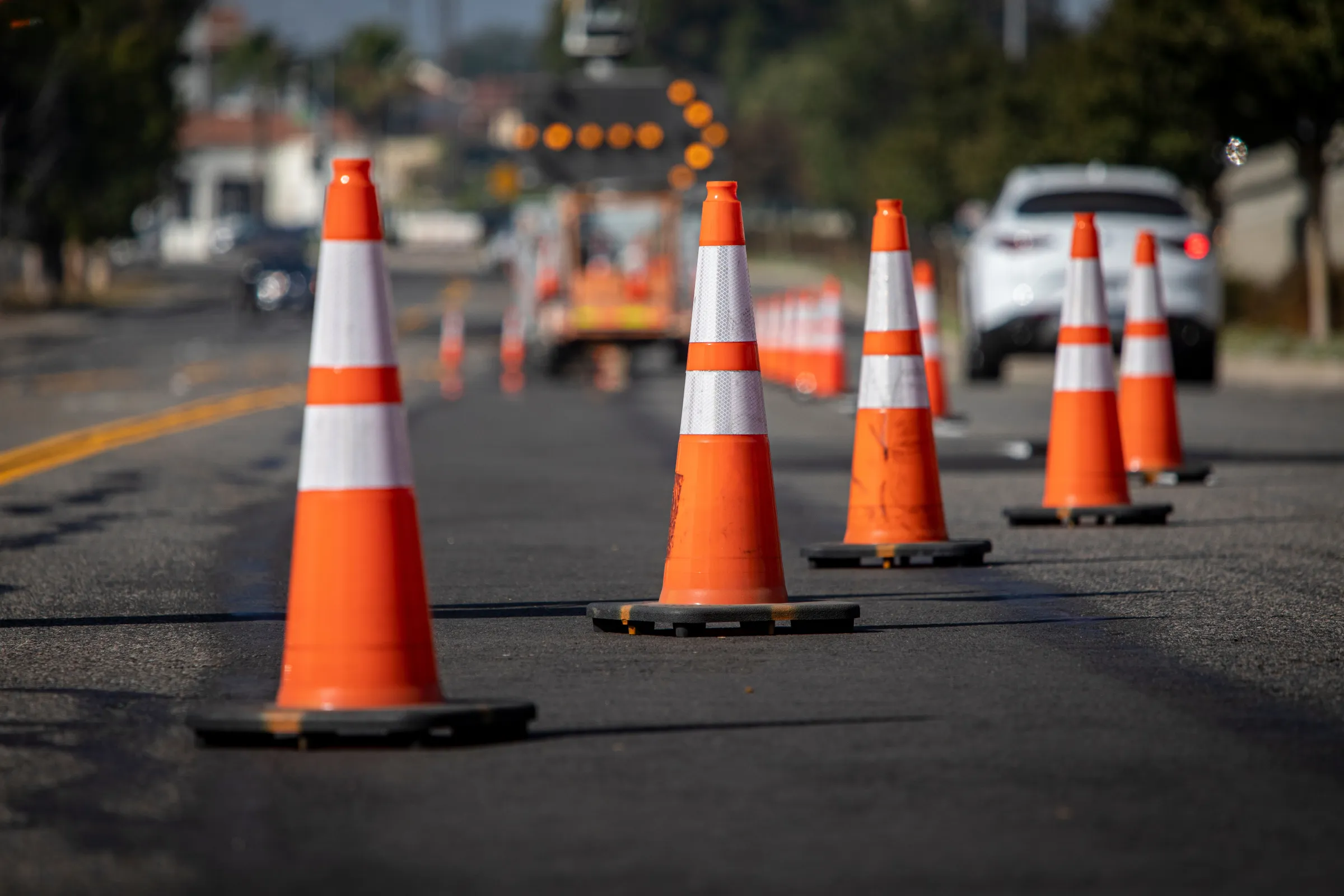 Traffic cones marking a temporary traffic management area on a road.